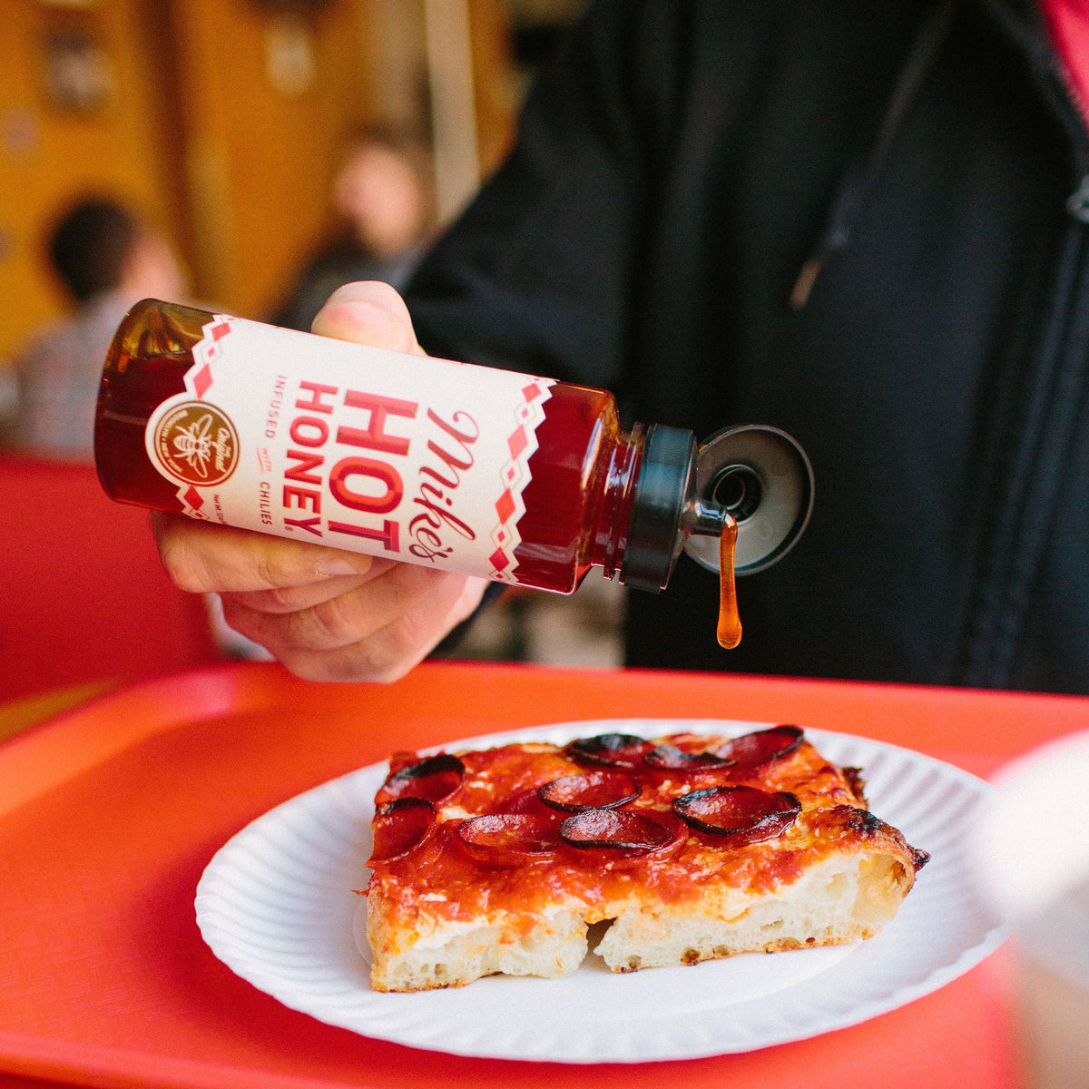 hot honey squeeze bottle with pizza
